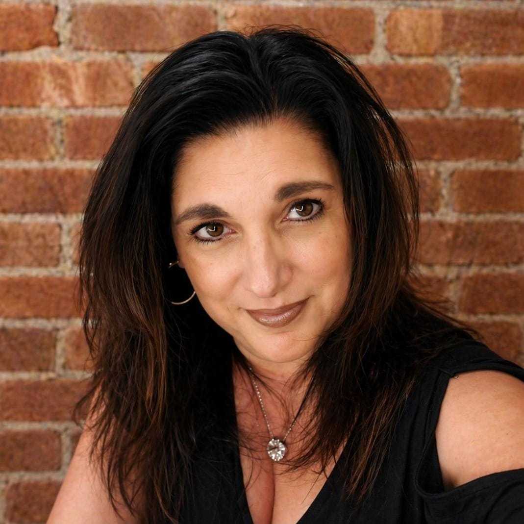 Portrait of Gina Earl, a professional stylist at Soho Salon, showcasing their expertise and style.