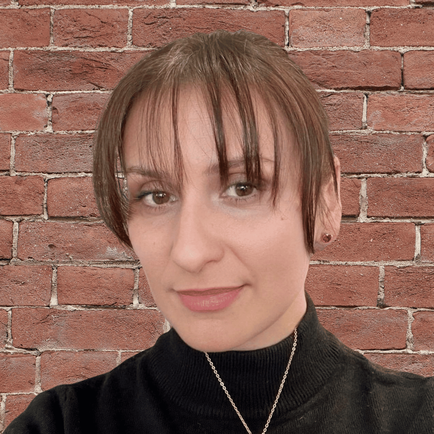 Portrait of Ivi Subotic, a professional stylist at Soho Salon, showcasing their expertise and style.