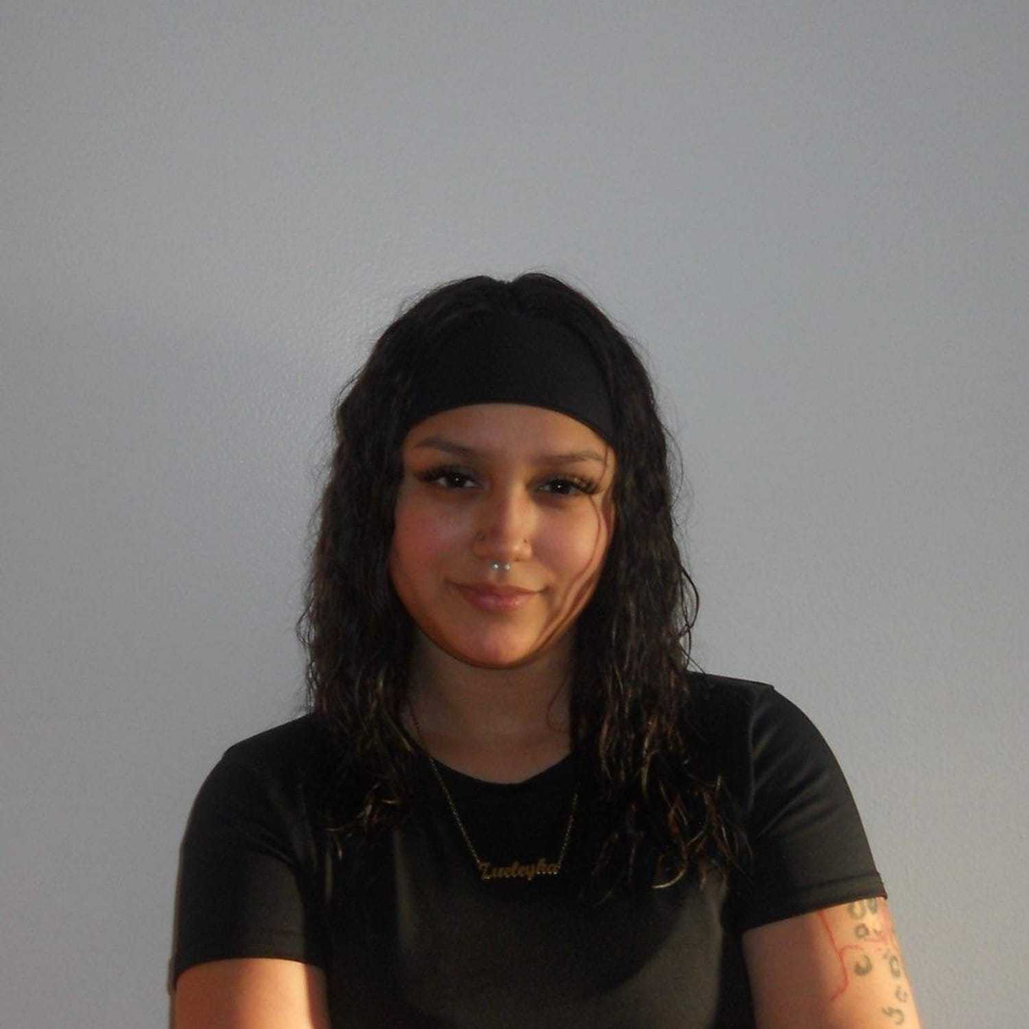 Portrait of Zueleyka Martinez-Cruz, a professional stylist at Soho Salon, showcasing their expertise and style.