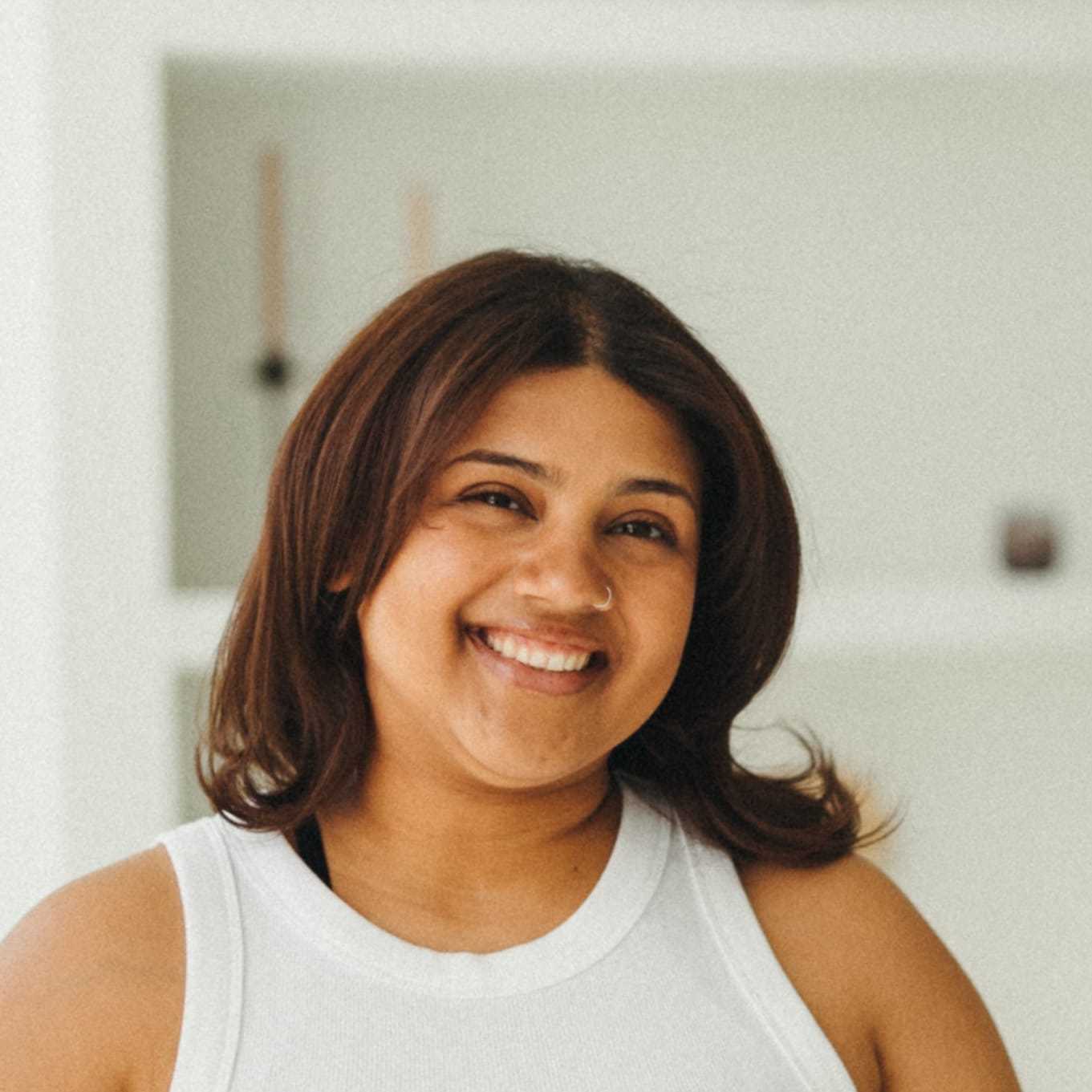 Portrait of Angie Vazquez, a professional stylist at Soho Salon, showcasing their expertise and style.